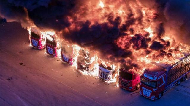 Burning trucks close Burning trucks close